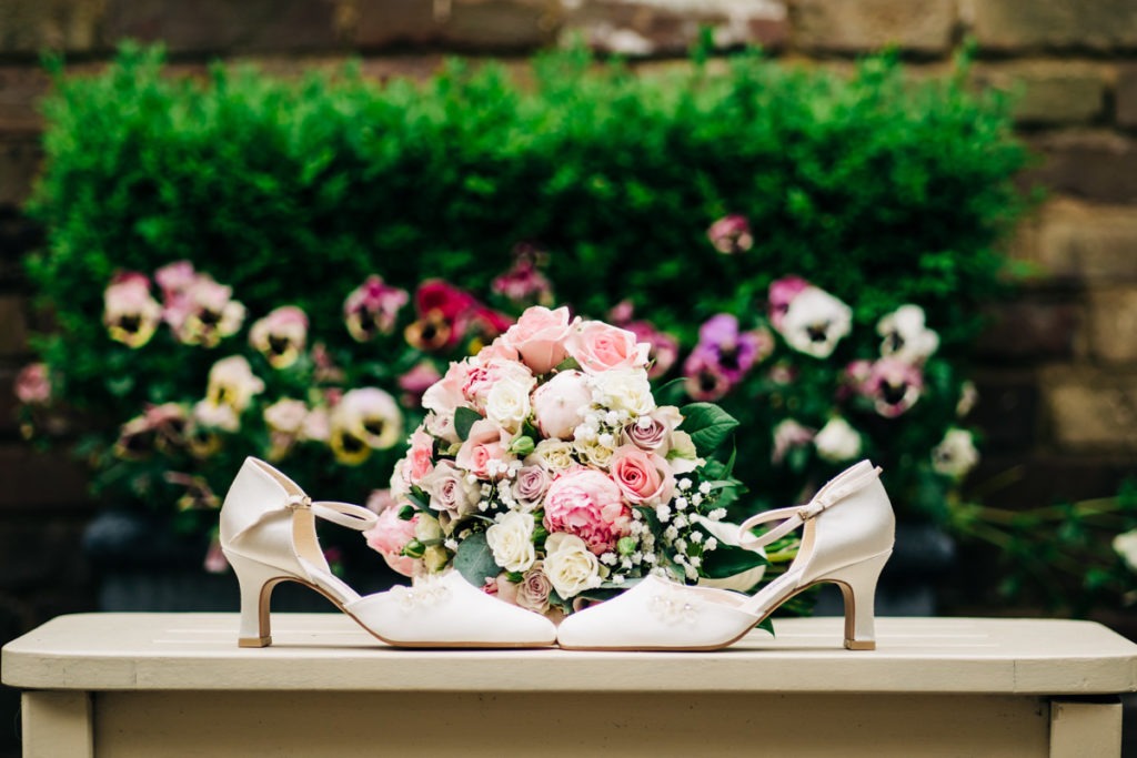 brides shoes and flowers at Knowle Country House