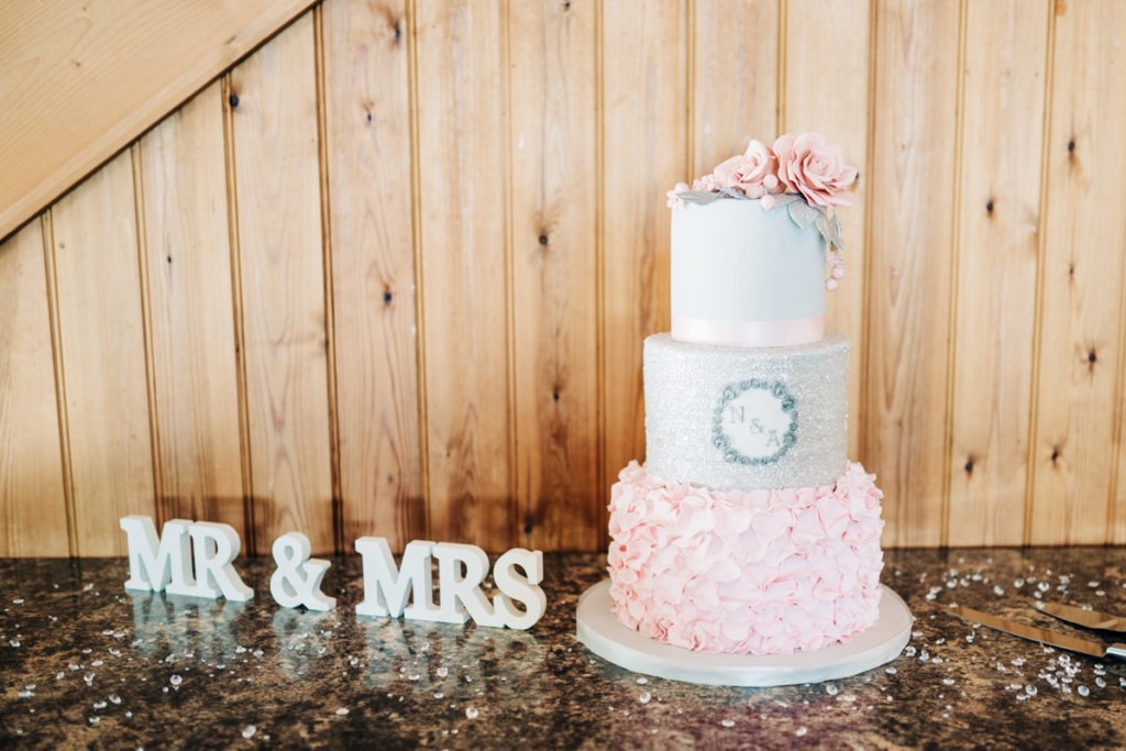 pink and white wedding cake at The Barnyard