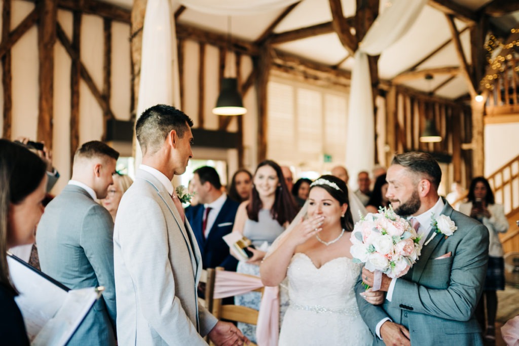 bride in shock as she walks down the aisle at The Barnyard