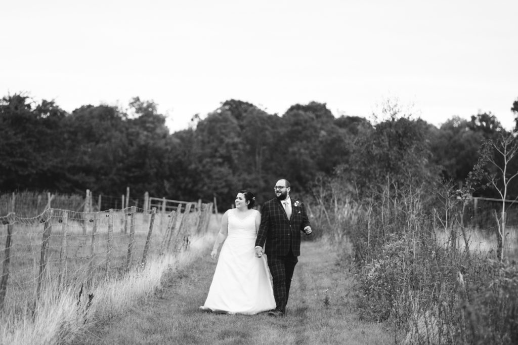 bride and groom walking in black and white