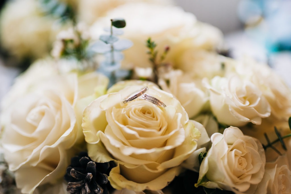 wedding rings on bridal flowers