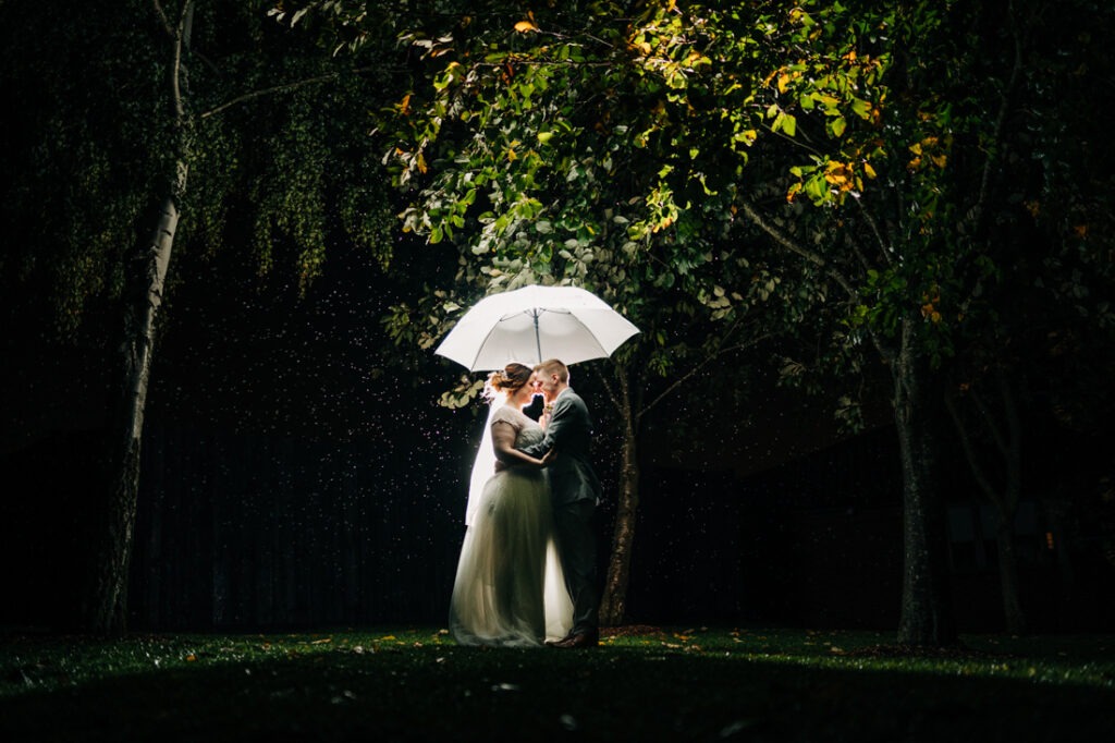 bride and groom portraits in the rain