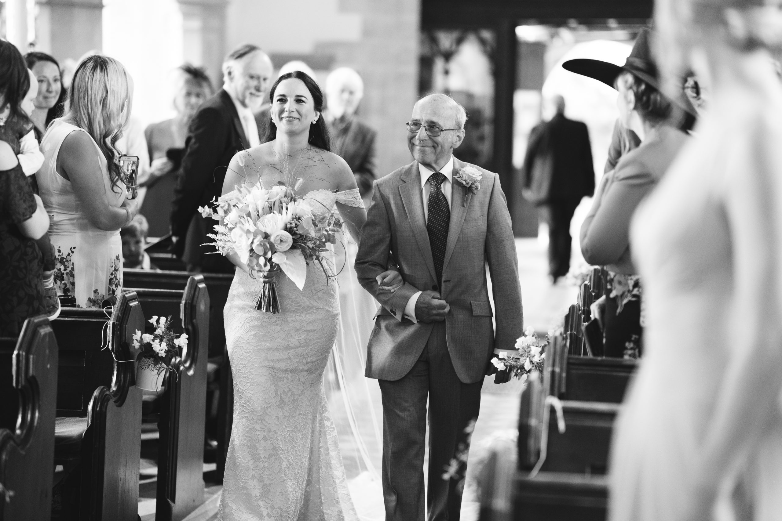 bride enters church with her father