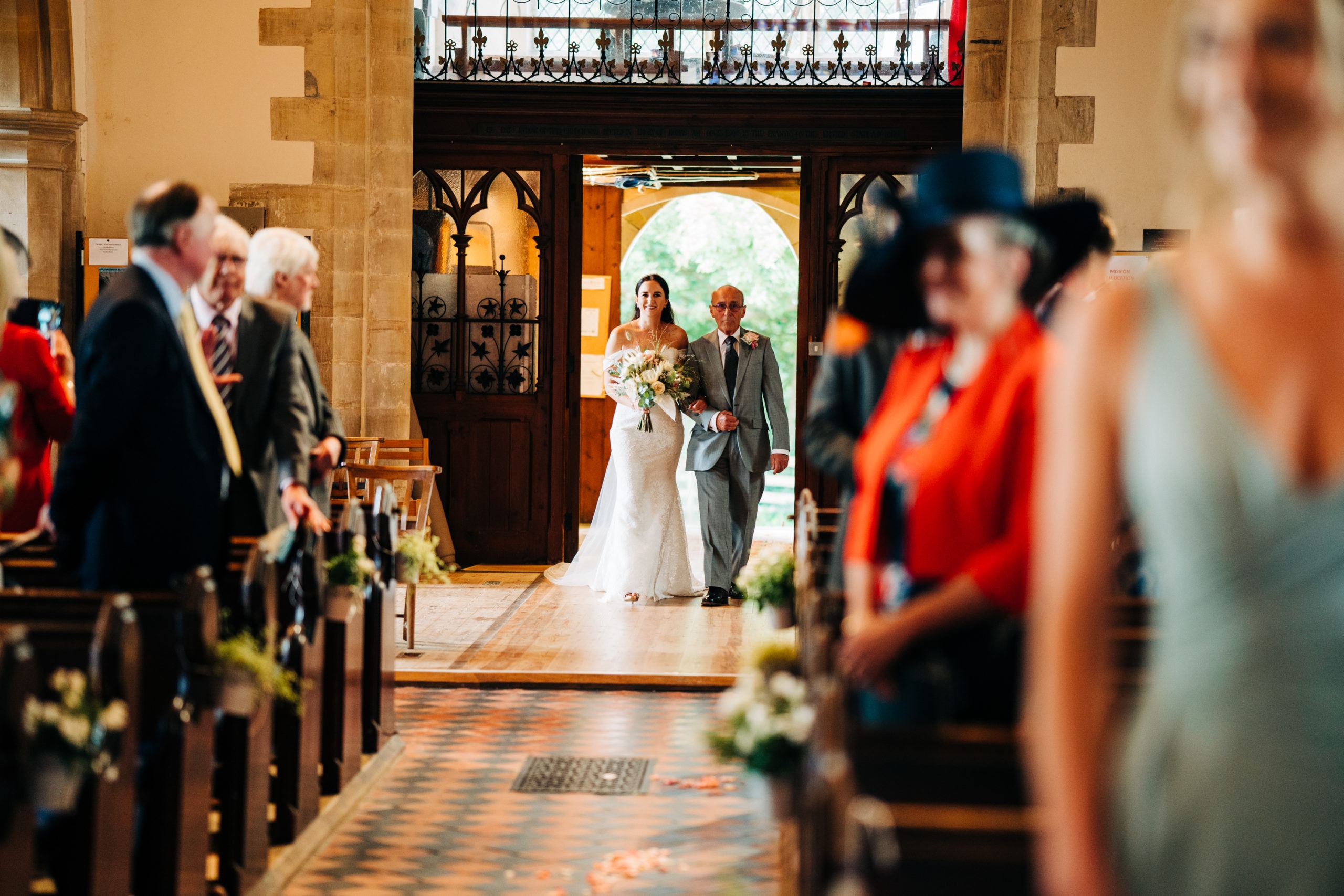 bride enters church with her father